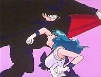 Tuxedo Kamen dodges Sailor Neptune's charge.